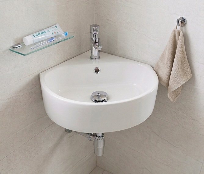 Corner wall-hung wash basin fitted into a tight bathroom corner