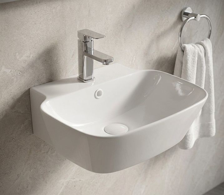 Wall-hung wash basin floating clear of the floor in a small bathroom